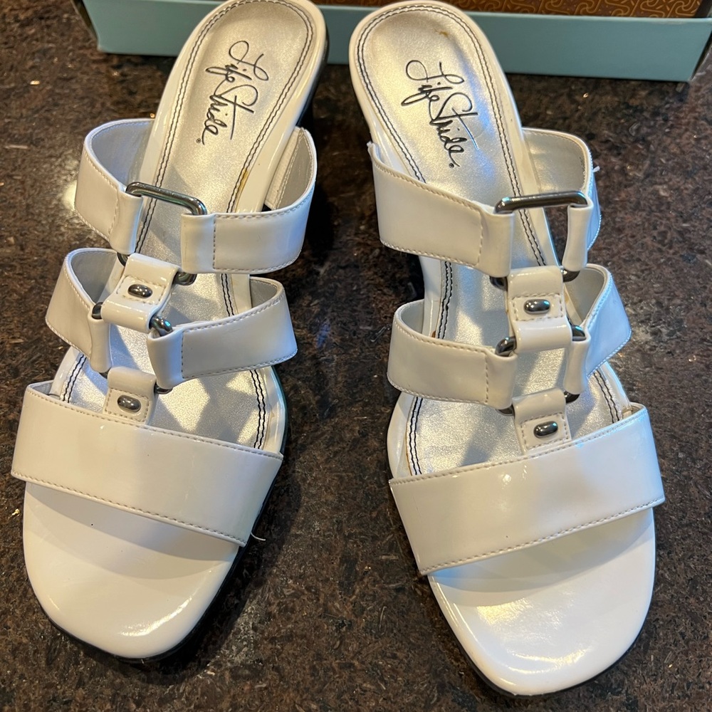 White sandal with small heel. Black sole. perfect condition.